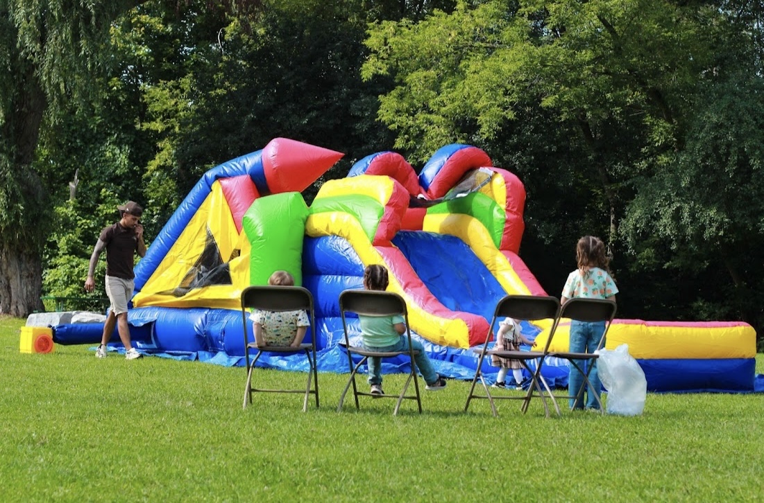 Kids enjoying a colorful bouncy castle setup outdoors